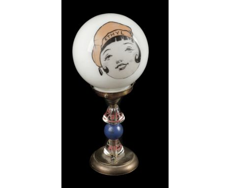 * Pratts. A Pratt's High Test Ethyl desk lamp, with milk glass globe shade applied with an sticker of a girl wearing an Ethyl