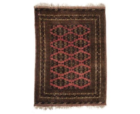 * Carpet. An early 20th century Oriental woollen carpet, with central medallion and geometric decoration on a red ground with