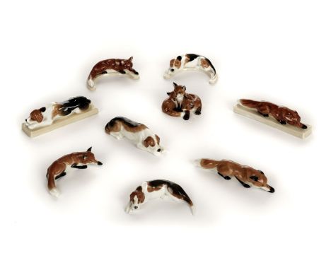 * Royal Worcester. A collection of fox and hounds, comprising three fox cubs (3131), purple mark, "Fox" modelled by Doris Lin