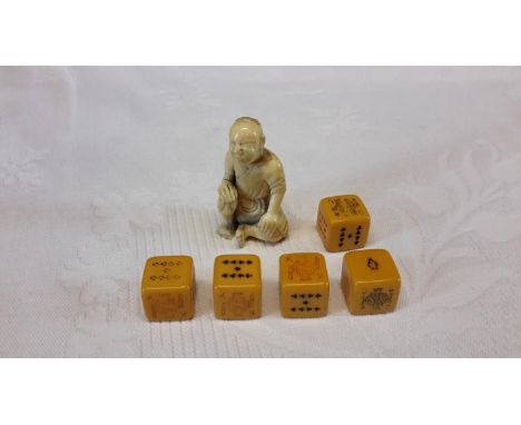Carved netsuke man sitting & 5 dices.