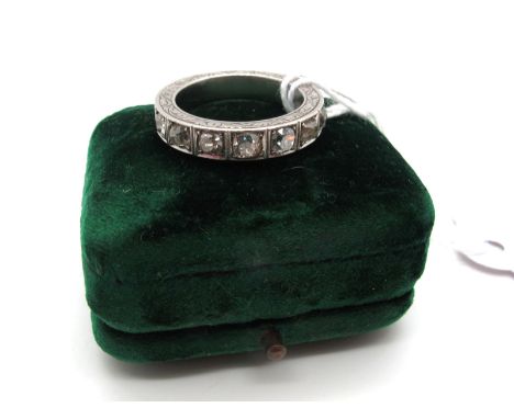An Old Cut Diamond Set Half Eternity Style Band, set to the front with seven old cut stones, within allover scroll engraved p