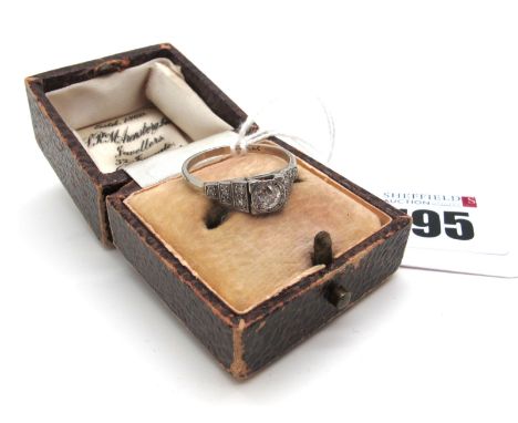 An Art Deco Diamond Ring, old cut set to the centre, between single cut inset stepped shoulders (indistinctly stamped ) (fing
