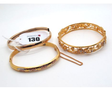 A Modern Decorative Hinged Bangle, of scrolling foliate two colour openwork design, stamped "22"; A Plain Bangle, (dents); an