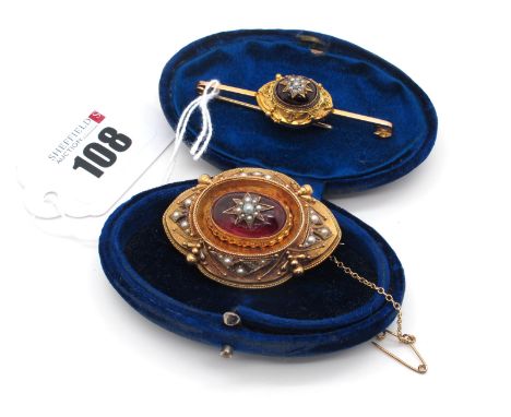 A Victorian Cabochon Garnet and Pearl Set Brooch, of shaped oval textured design, with pearl set highlights (losses), with gl