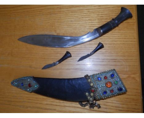 A 19thC kukri in decorative scabbard.