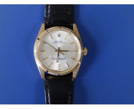A gent's 18ct gold Rolex Oyster Perpetual wrist watch with champagne dial having gold baton numerals, centre seconds, replace