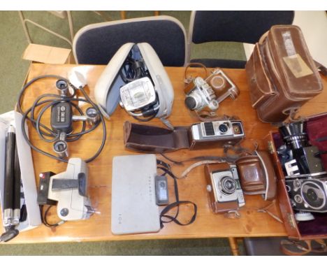 An old Polaroid camera, a Bolex cine camera and other related items.