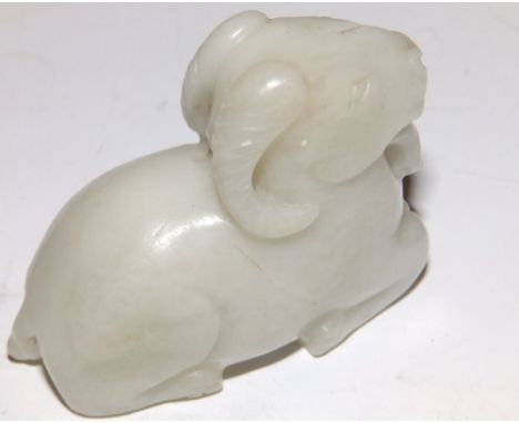 A 20thC Chinese jade carving of a kneeling ibex.