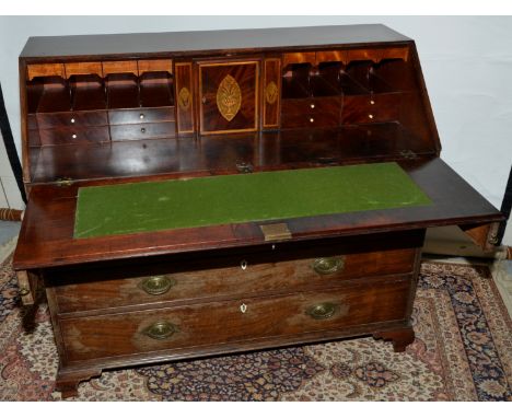 Large 19th C mahogany bureau with fall front above two short and three long drawers on raised bracket feet with oval gilt met