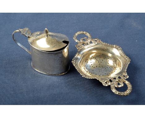 Birmingham silver hallmarked mustard pot and  Birmingham 1908 silver hallmarked tea strainer (2)