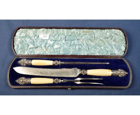 Cased three piece carving set with ivorine handles and embossed Sheffield silver hallmarked mounts, the carving knife blade m