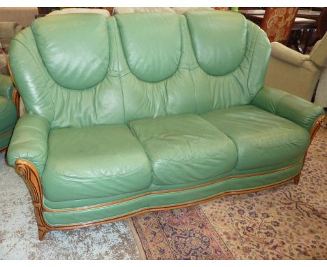 Green leather three piece suite comprising of three seat sofa and a pair of matching armchairs 