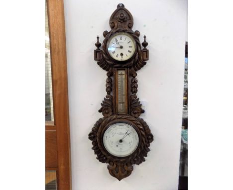 *Barometer. Victoria oak cased barometer clock thermometer by Sewill, circa 1890,  with extensive foliate and nautical motif 