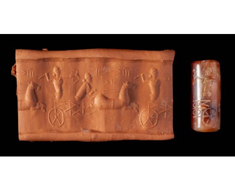 *Neo-Assyrian carnelian cylinder seal, 800-600 BC,  two figures hunting on chariot, text above, 27mm x 11mm  (1)