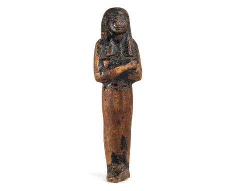 *Ancient Egypt. 19th Dynasty,  carved wood mummiform Shabti, probably of Seti I, coated in black resin, wearing tripartite wi