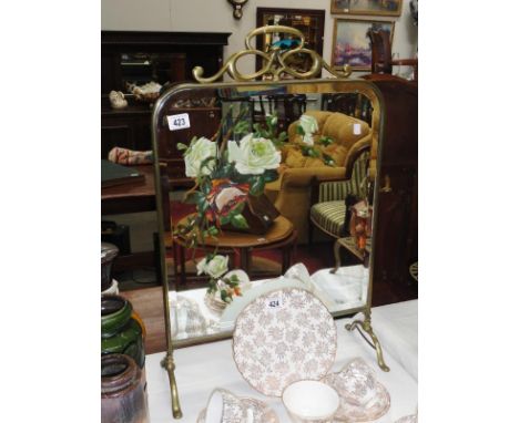 A brass fire screen with hand painted mirror inset.