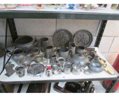 A shelf of assorted metal ware including pewter,.