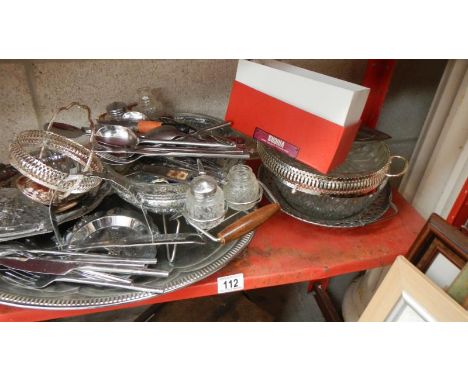 A shelf of silver plate, cutlery etc.,