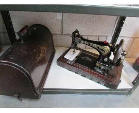 A cased manual sewing machine,