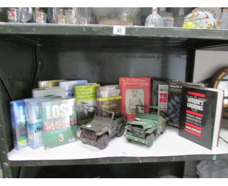 A quantity of military books. 2 jeeps etc, one shelf.