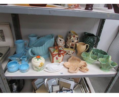 A shelf of assorted pottery including Wade, Sylvac etc.