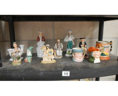 A shelf of figures, Toby jugs etc.,