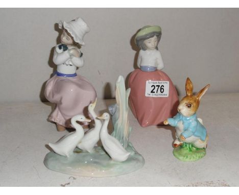 3 NAO figures and a Beatrix Potter figure.