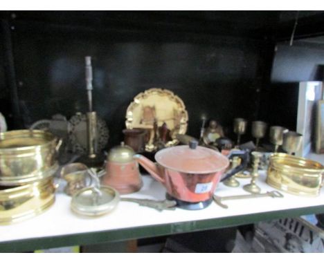 A shelf of assorted brass and copper.