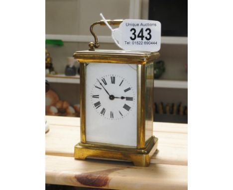 A brass carriage clock.
