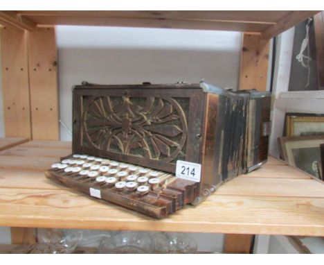 An old accordion in wooden case.