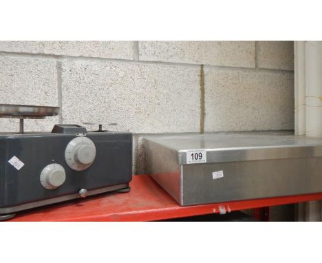 A set of scales and a stainless steel lidded box.