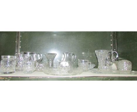 A shelf of miscellaneous glass ware including cut glass, jugs, vases etc.,