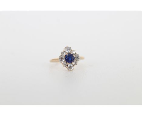 Sapphire &amp; Diamond Petite Gold Ring. Center  round cut sapphire surround by 8 smaller  accent diamonds.  Ring Size: 3.25 