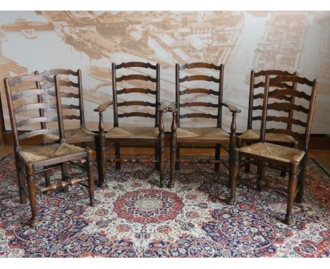 A George III set of six Lancashire style oak wavy ladder back dining chairs, two carvers and four chairs with rush seats, tur