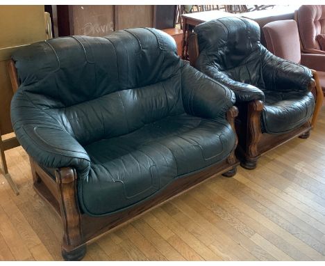 A two seater dark green leather sofa H95cm, L-138cm, D-85cm, together with a matching armchair (2)