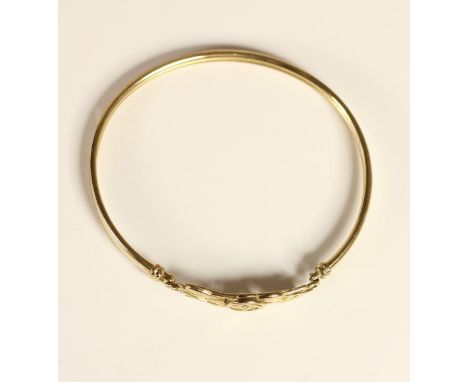 A 9ct gold bangle with Celtic floral decoration, 5.2gm 