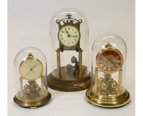 A brass, 400 day Bentima anniversary clock 19 cm, together with a Kern &amp; Sohne, red faced anniversary clock 23 cm, and a 
