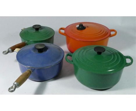 Two Le Creuset cast iron sauce pans and two Le Creuset signature cast iron casserole dishes, a set of copper &amp; brass grad