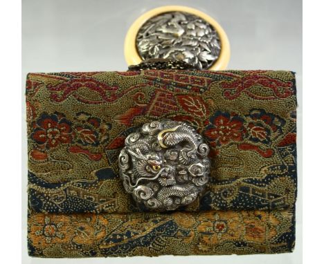 A JAPANESE WOVEN CLOTH PURSE, with embossed silver dragon mount and large ivory manju netsuke toggle with embossed silver ins