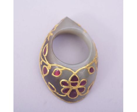 A FINE INDIAN JADE ARCHER'S THUMB RING, inset with coloured stones and gilt metal tracery, 4.5cm.