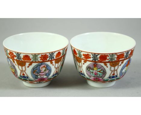 A PAIR OF CHINESE FAMILLE ROSE 'BARAGON TUMED' PORCELAIN CUPS, each cup enamelled with buddhistic emblems, the bases with Mon