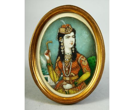 AN INDIAN MINIATURE OVAL PORTRAIT depicting the wife of Muhammad Shah, on ivory, encasced within a gilt metal frame and glaze