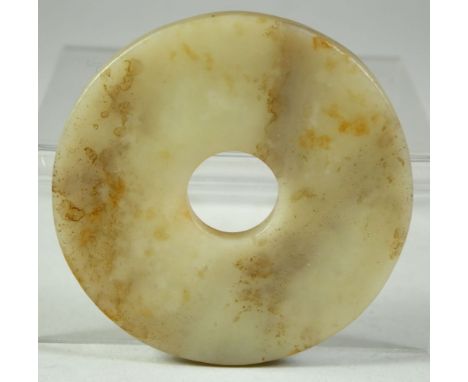 A SMALL CHINESE CARVED JADE ARCHAIC BI DISK, 8cm diameter.