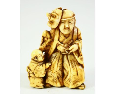 A JAPANESE CARVED IVORY NETSUKE, of a noh actor with a child by his side, 4.5cm high.