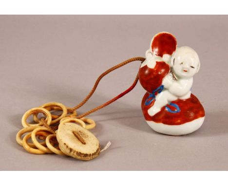 A 19TH CENTURY JAPANESE MEIJI PERIOD PORCELAIN NETSUKE OF A BOY - the netsuke modeled as a boy riding a double gourd - with s