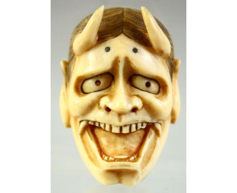 A JAPANESE CARVED IVORY NOH MASK NETSUKE, signed to the reverse, 5cm.