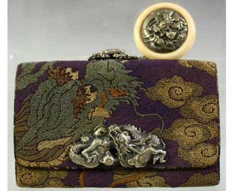 A JAPANESE WOVEN CLOTH PURSE, with embossed silver dragon mount and large ivory manju netsuke toggle with embossed silver ins