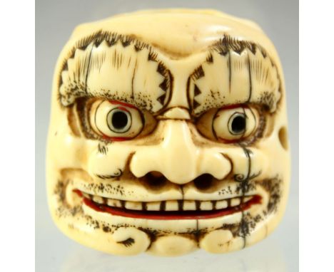 A JAPANESE CARVED IVORY DOUBLE SIDED NOH MASK NETSUKE, signed to the base, 4cm wide.