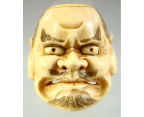 A JAPANESE CARVED IVORY NOH MASK NETSUKE, signed to the reverse, 4cm.