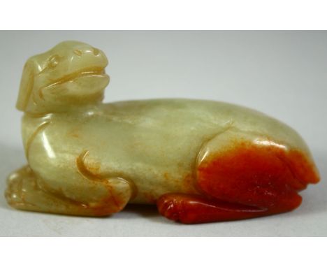 A CHINESE CARVED JADE MODEL OF A RECUMBENT BEAST, 6.5cm long.